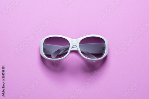 Studio shot of white sunglasses on pink background, Summer is coming concept