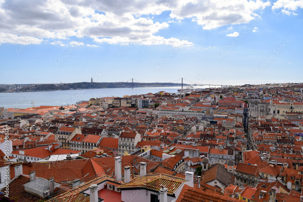 Rooftops of Lisbon looking out towards the Tagus River and the 25 de Abril Bridge in Portugal