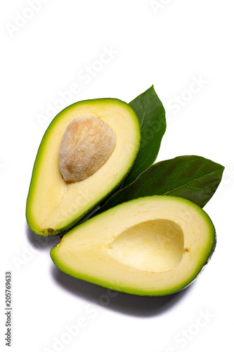 Fresh organic ripe green whole and sliced Fuerte avocado with leaves, copy space close up isolated on white background