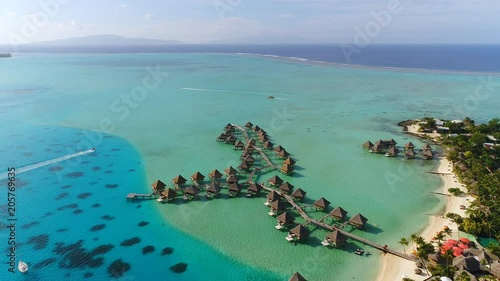 Aerial view of tropical paradise of Bora Bora island, turquoise crystal clear water of scenic blue lagoon, typical over water bungalows, Matira Point - South Pacific Ocean, French Polynesia from above photo