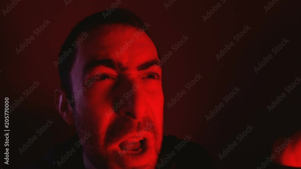 Man with angry facial expression screaming out loud and waving gesture with his hand Man with angry facial expression screaming out loud and waving gesture with his hand