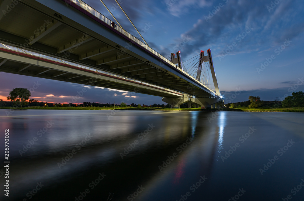 modern bridge over Vistula river, Krakow, Poland, illuminated in the night