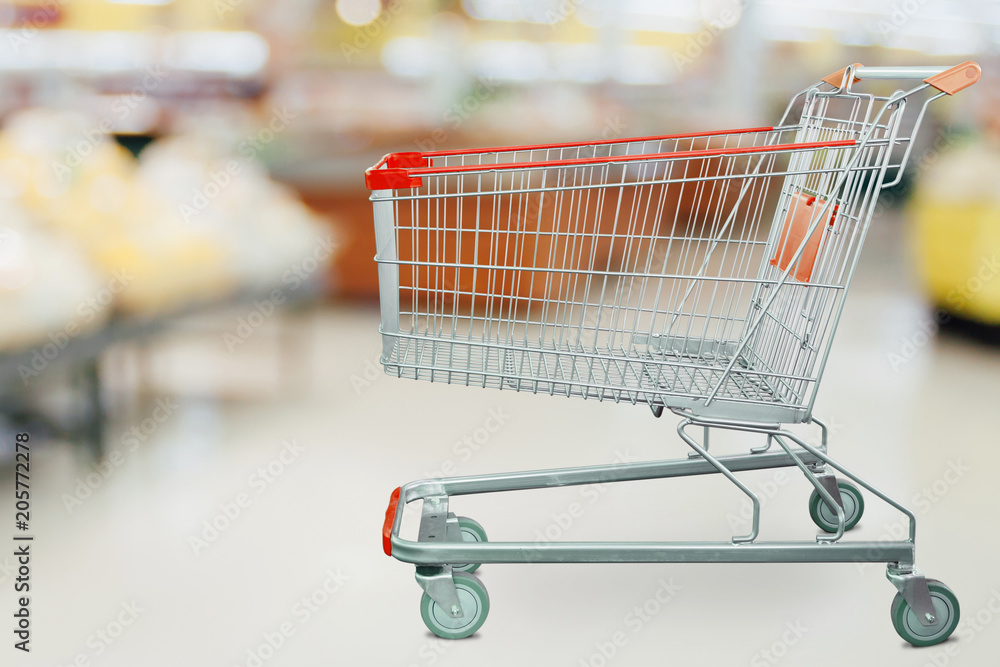 Supermarket grocery store with empty shopping cart Supermarket grocery store with empty shopping cart