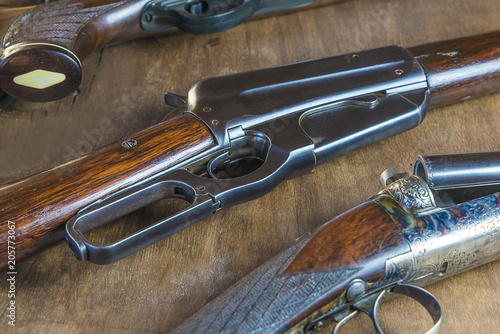 Beautiful hunting gun on wooden background close up, selective focus