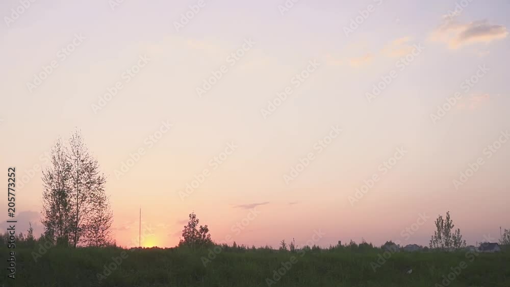 Silhouette of a car in a field at sunset. The road and the field. The car on the field. Silhouette of a car in a field at sunset. The road and the field. The car on the field.