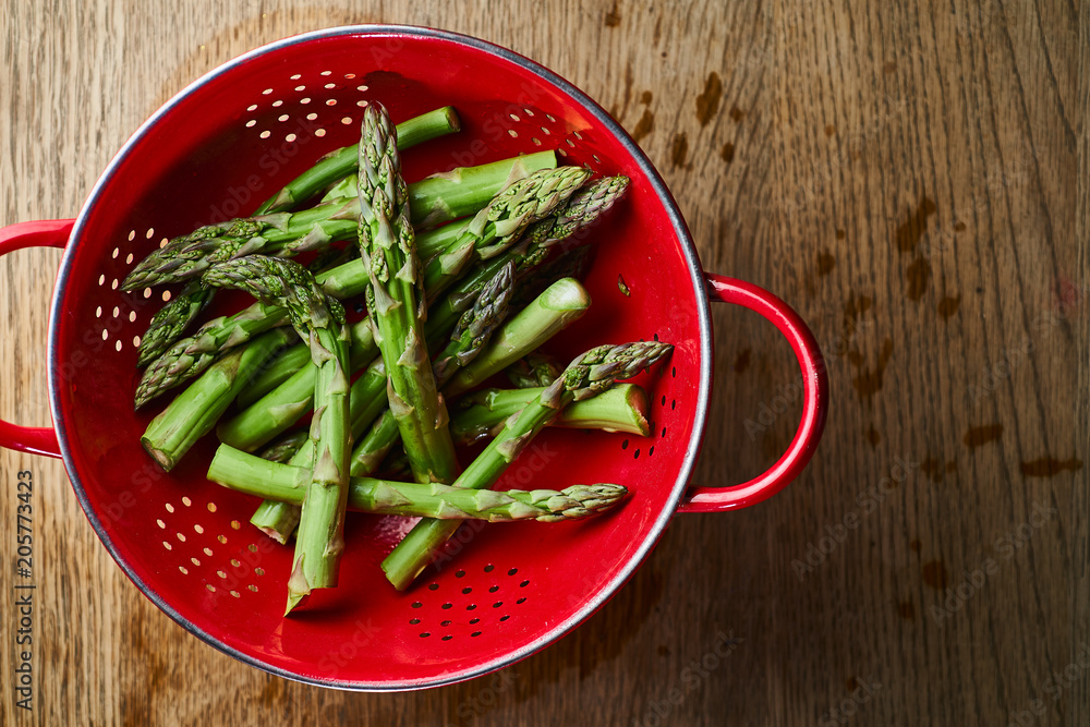 green asparagus on a red background green asparagus on a red background