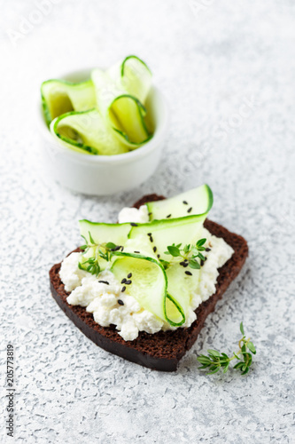 Toasts with ricotta, cucumber and black sesame