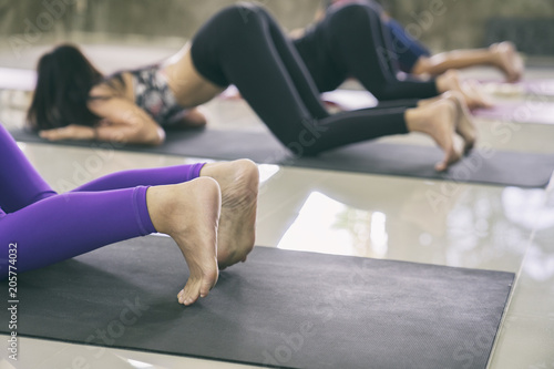 Women exercising in fitness studio yoga classes
