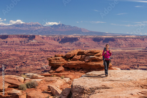 Hiker rests in Canyonlands National park in Utah, USA