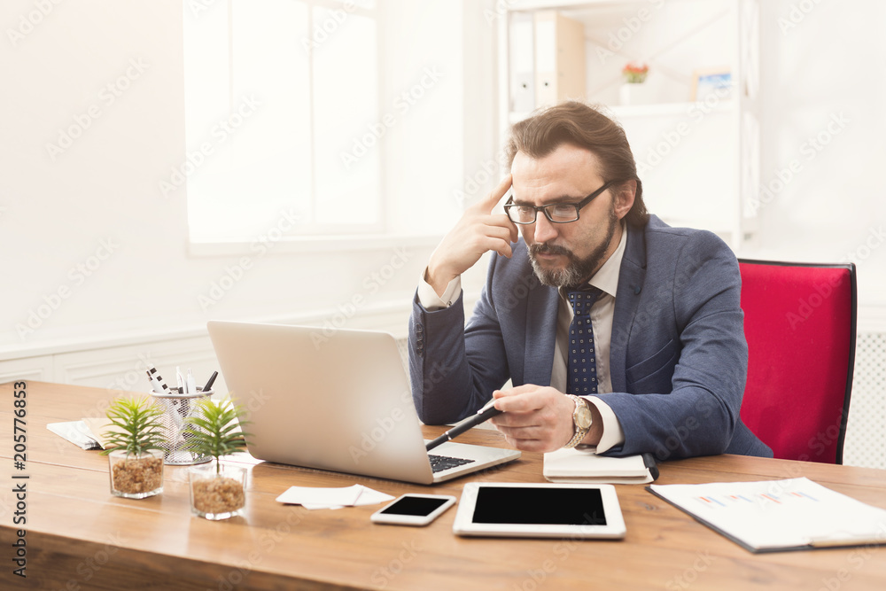 Concentrated businessman working with laptop Concentrated businessman working with laptop