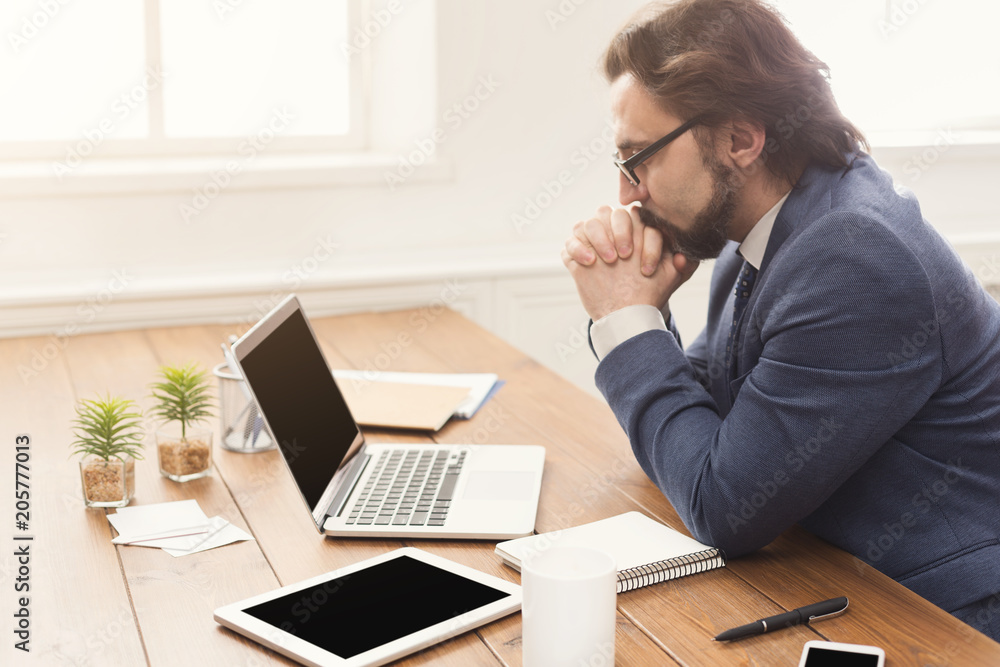 Concentrated businessman working with laptop Concentrated businessman working with laptop