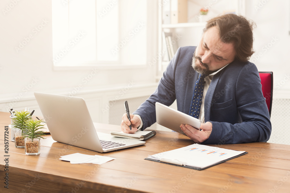 Concentrated businessman talking on mobile phone Concentrated businessman talking on mobile phone