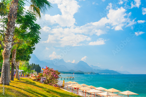 Beautiful beach with green trees in Kemer, Turkey. © smallredgirl