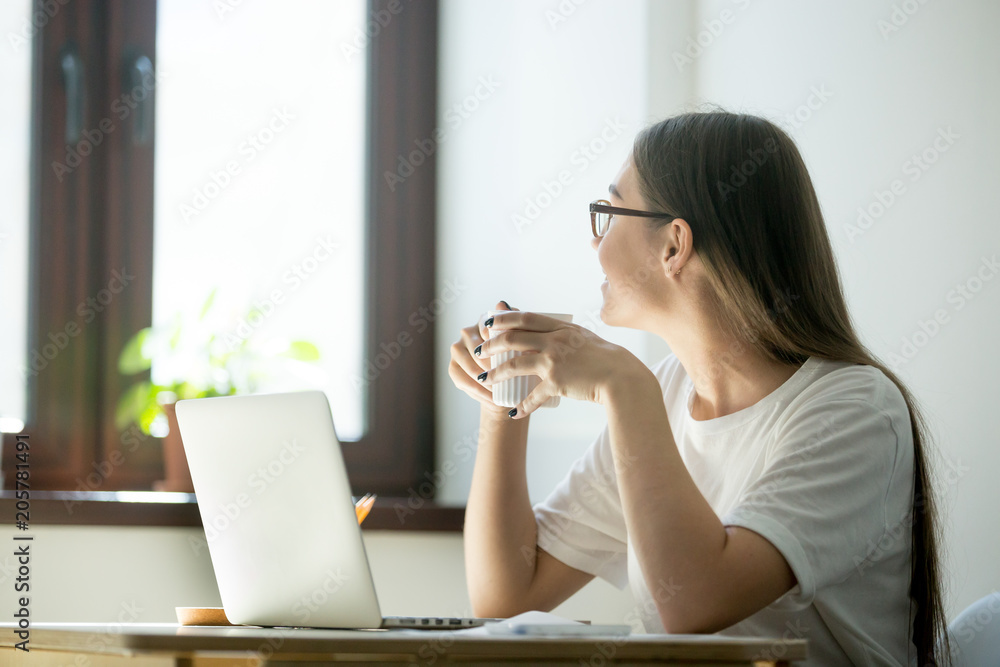 Smiling female worker looking in the window, taking break, having rest after work, enjoying coffee. Woman thinking about new opportunities, dreaming, being distracted from work. Smiling female worker looking in the window, taking break, having rest after work, enjoying coffee. Woman thinking about new opportunities, dreaming, being distracted from work.
