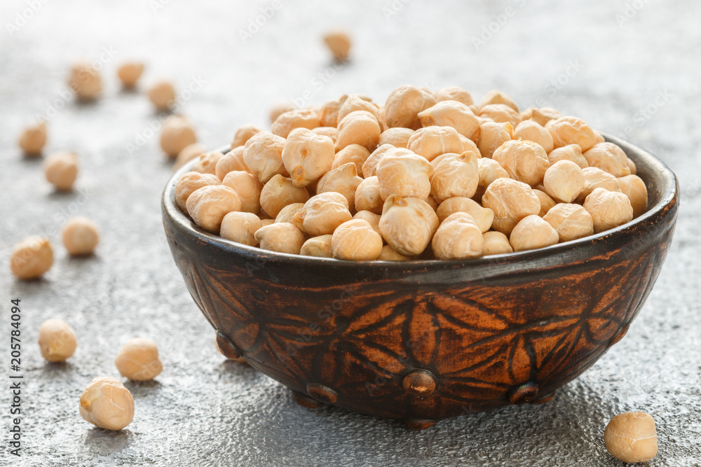 Raw Chickpeas in a brown clay bowl Raw Chickpeas in a brown clay bowl