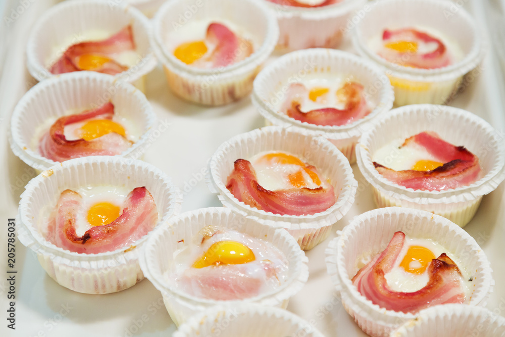 Portions of scrambled eggs and bacon for breakfast Portions of scrambled eggs and bacon for breakfast