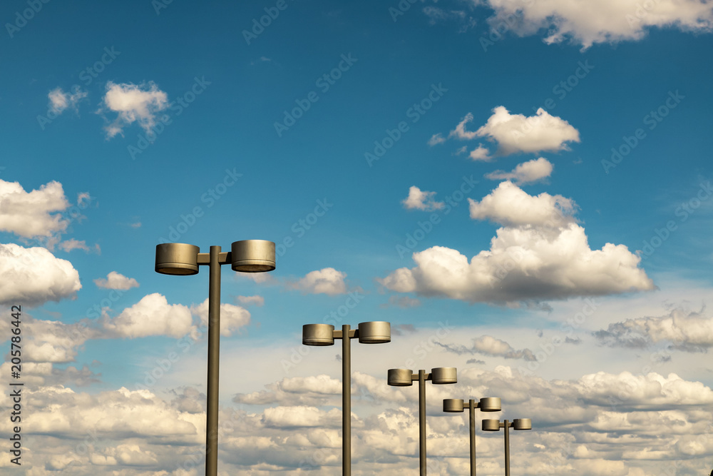 Street lanterns of steel color against the blue sky and beautiful clouds, city Dnipro, Ukraine, (Dnepropetrovsk, Dnipropetrovsk, Dnepr)