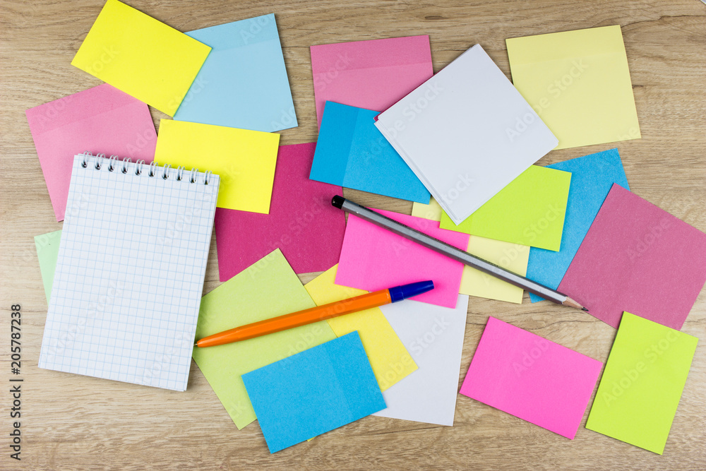 Color paper sticks, pen and notepad. Free space for text. Wooden table Color paper sticks, pen and notepad. Free space for text. Wooden table