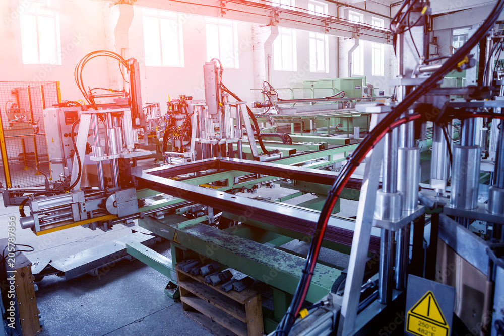Naklejka premium Factory for aluminum and PVC windows and doors production. Details industrial equipment.