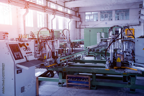 Factory for aluminum and PVC windows and doors production. Details industrial equipment.