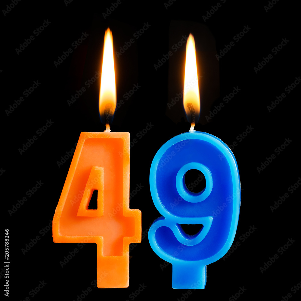 Burning birthday candles in the form of 49 forty nine for cake isolated on black background. Burning birthday candles in the form of 49 forty nine for cake isolated on black background.