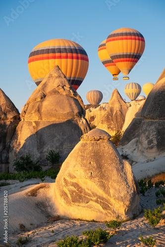 Airballons adove high rock. Beautiful natural landscape at the summer time