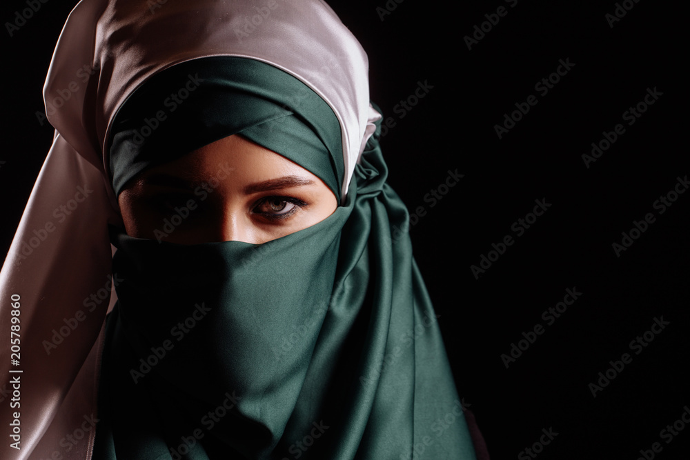 successful Muslim businesswoman isolated on the black background. copy space successful Muslim businesswoman isolated on the black background. copy space