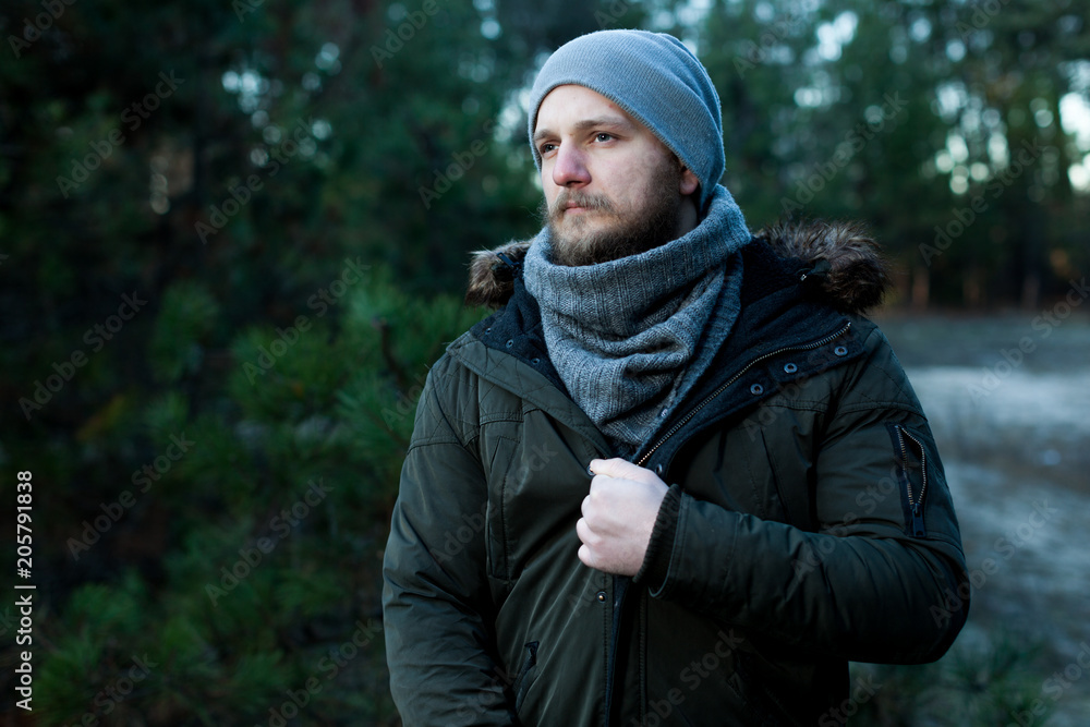 Portrait brutal bearded hipster man in the forest Portrait brutal bearded hipster man in the forest