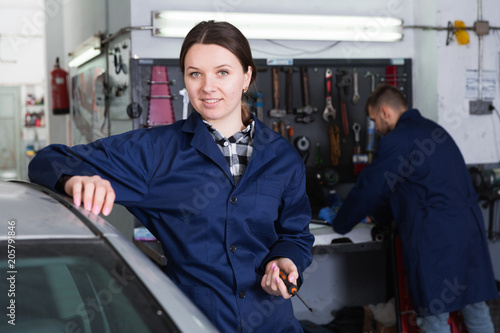 Portrait of female who is standing on her workplace © JackF