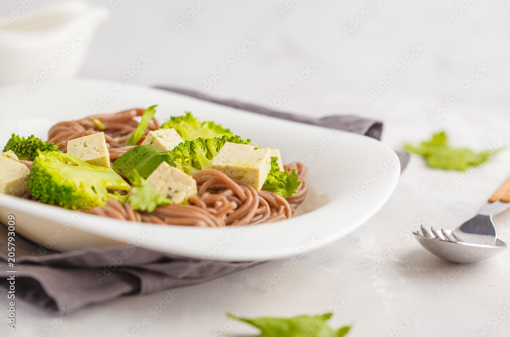 Vegetarian Soba Noodles with tofu and broccoli, white background. Healthy vegan food concept. Vegetarian Soba Noodles with tofu and broccoli, white background. Healthy vegan food concept.