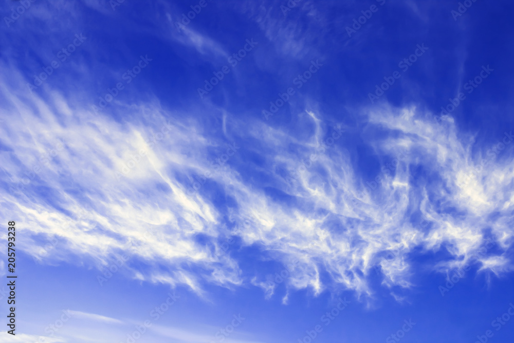 Cirrus fibratus, cirrus clouds in Latin language. Cloud formation, background with blue sky and cirrus clouds. Upper atmosphere, troposphere. The harbinger of atmosphere occlusion fronts.