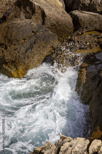 Wave meets limestone rocks at Dwejra Bay, Gozo, Malta