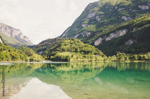 Fototapeta Naklejka Na Ścianę i Meble -  Lago di tenno with mountain and trees reflection in water. Tenno, Privincia di Trento, Trentino0Alto Adige, Italy