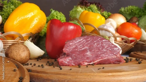 Still life with raw pork meat and fresh vegetables