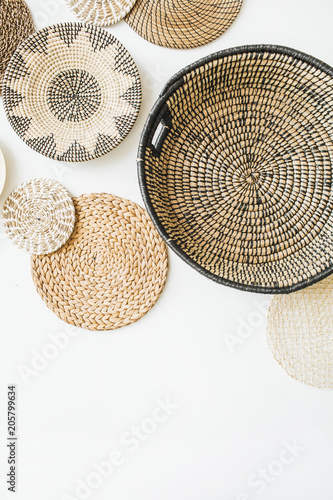 Decorative straw plates on white wall. Modern minimal home interior design.