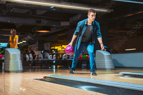 Man throwing ball in bowling alley