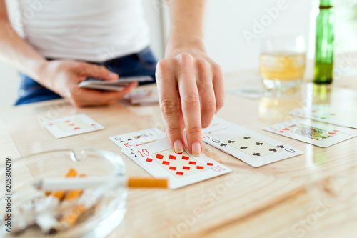 The hands of a woman playing poker. Addiction concept.