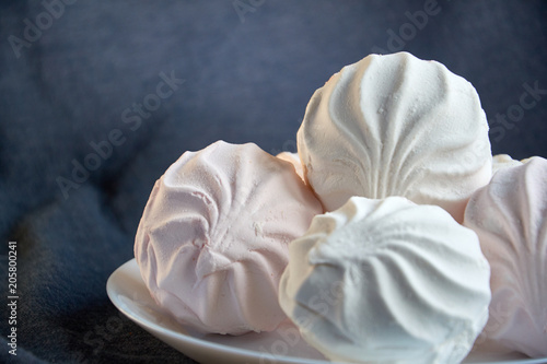 White zephyr marshmallow on porcelain plate
