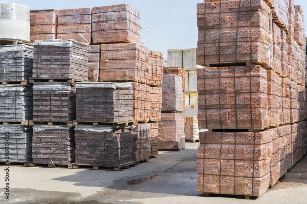 pallets with bricks in the building store. Racks with brick. Masonry, stonework. Several pallets with concrete brick stacked on top of each other in depot. new bricks on pallets. pallets with bricks in the building store. Racks with brick. Masonry, stonework. Several pallets with concrete brick stacked on top of each other in depot. new bricks on pallets.