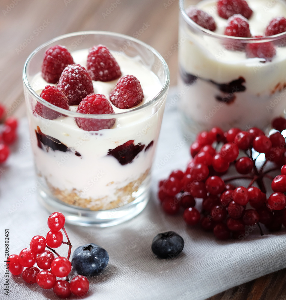yogurt with muesli and berries on a wooden table yogurt with muesli and berries on a wooden table