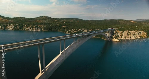 Wallpaper Mural wide aerial shot of a big croatian bridge with pine flora and mountains in the background. camera moves sidewards along with the trafic on the bridge. Torontodigital.ca