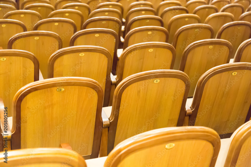 Naklejka premium Brown vintage seats armchairs in theater. Theater or conference room interior.