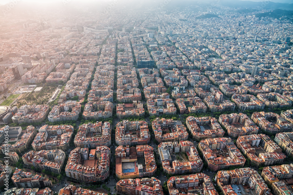 Naklejka premium Aerial view of Barcelona cityscape with typical urban grid, Spain. Light leak effect applied