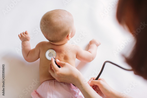 Doctor Using A Stethoscope To Listen To Baby's back , Baby Health Concep