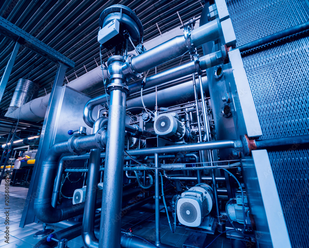 Modern interior of a brewery. Barrels and pipes. Factory interior. Modern interior of a brewery. Barrels and pipes. Factory interior.