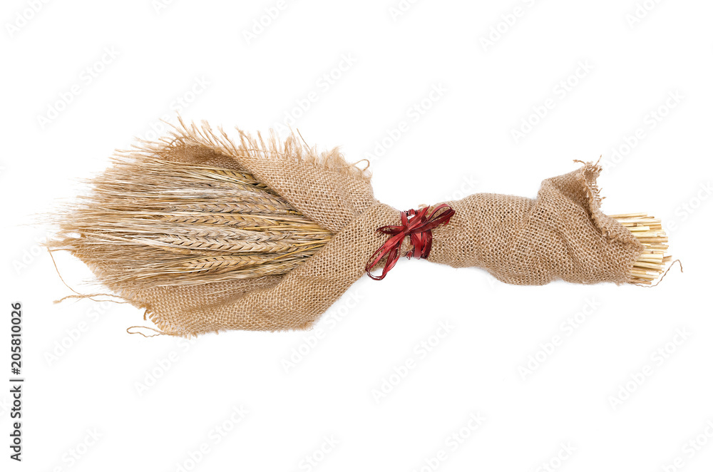 A bouquet of rye ears wrapped in sackcloth isolated on white background.