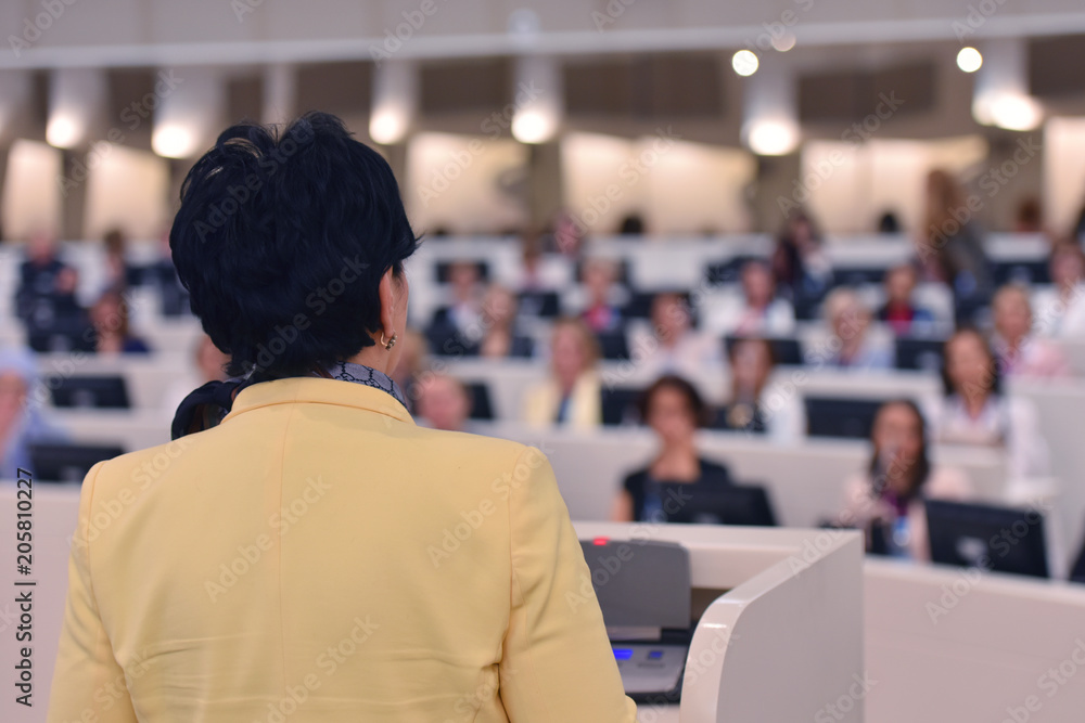 Fototapeta premium Business woman as leader speaking at Conference. Audience at the conference room or hall , representing model of economic development and startup business and interreligious relations