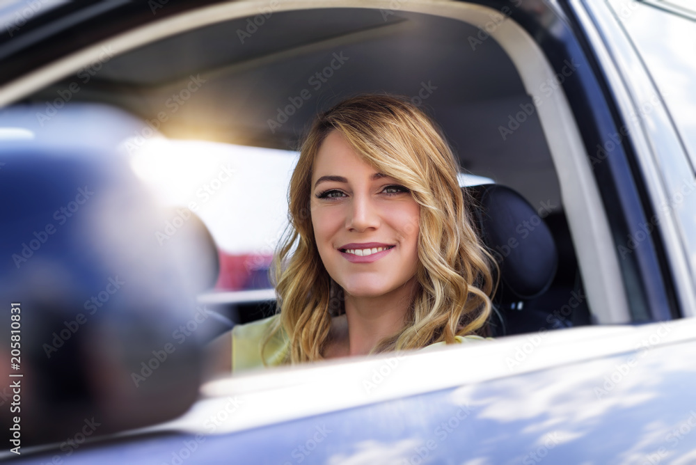 Attractive young woman driving a car.