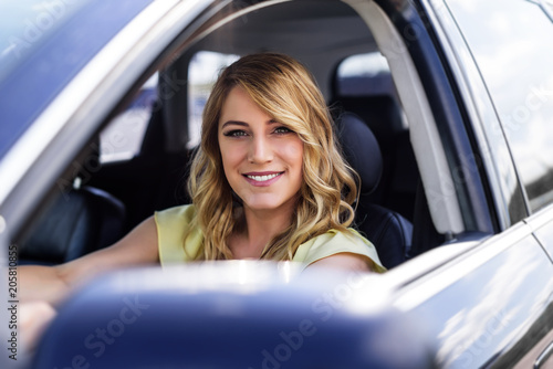 Attractive young woman driving a car. © Denis Rozhnovsky