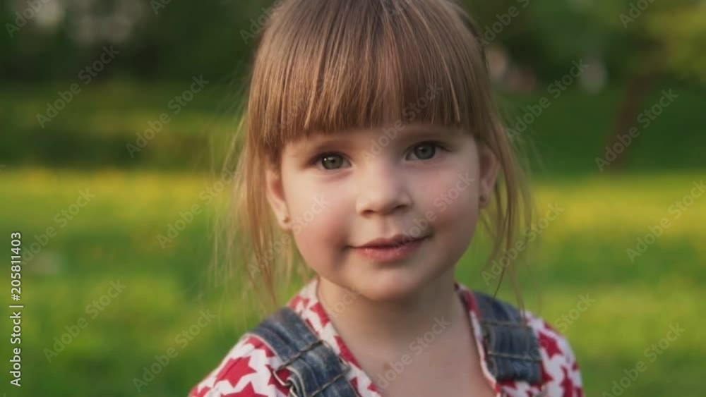 Joyful little girl looking at camera and smiling